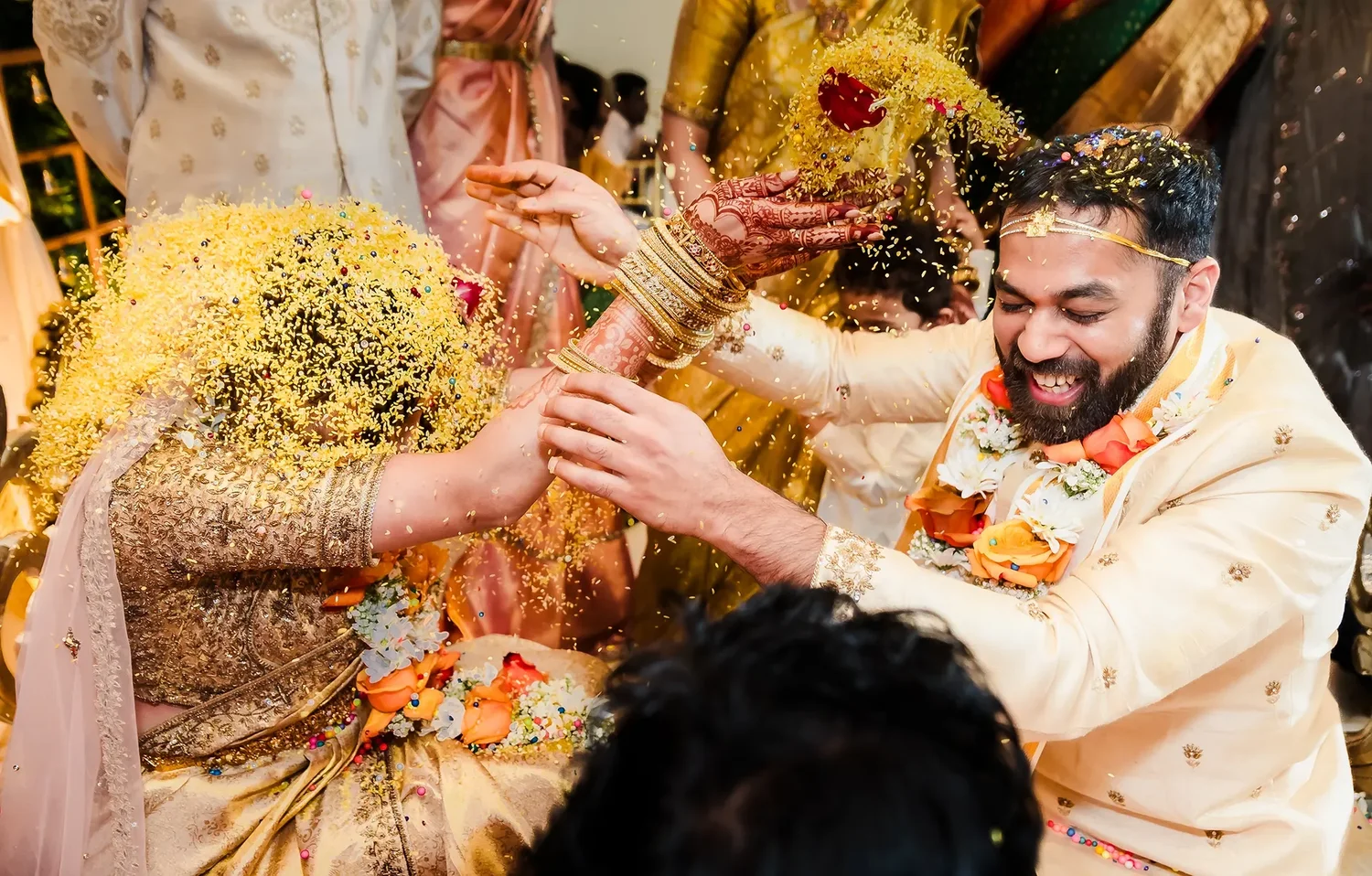 Family showering a couple with flowers during a ceremony ritual